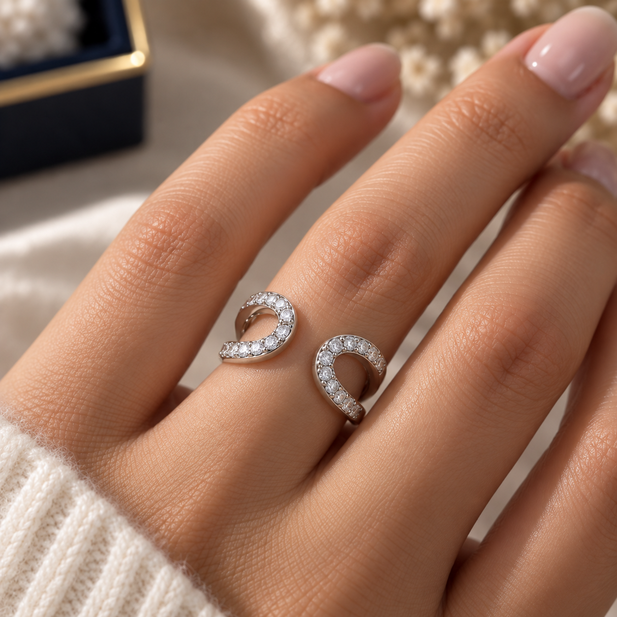 Mirrored Curve Pavé Ring with two mirrored open curves and sparkling pavé-set stones worn elegantly on a finger.
