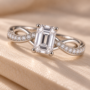 Close-up of the Emerald-Cut Infinity Diamond Ring showing the emerald-cut centre stone, four-prong setting, and symmetrical infinity-style bands with delicate pavé detailing.