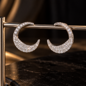 Pavé diamond crescent earrings in 925 sterling silver on a dark luxury background