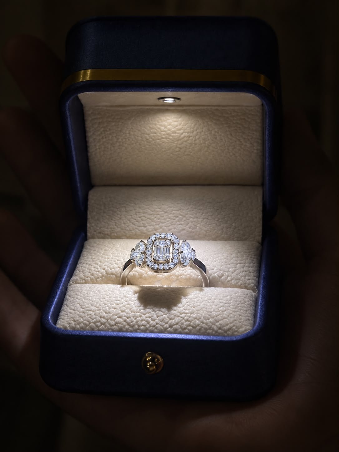 Majestic Halo Ring in 925 silver featuring a sparkling centre stone surrounded by a diamond halo and elegant side stones, displayed in a navy blue jewellery box.