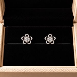 Diamond flower studs with pavé diamond detailing on black velvet