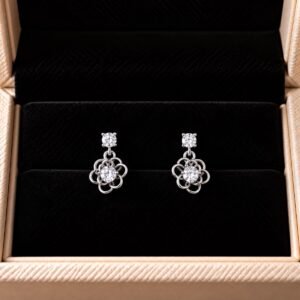 Floral diamond drop earrings displayed on black box