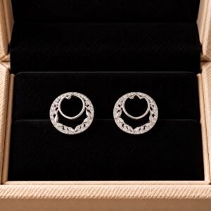 Diamond heart hoop earrings with sparkling detailing on black velvet